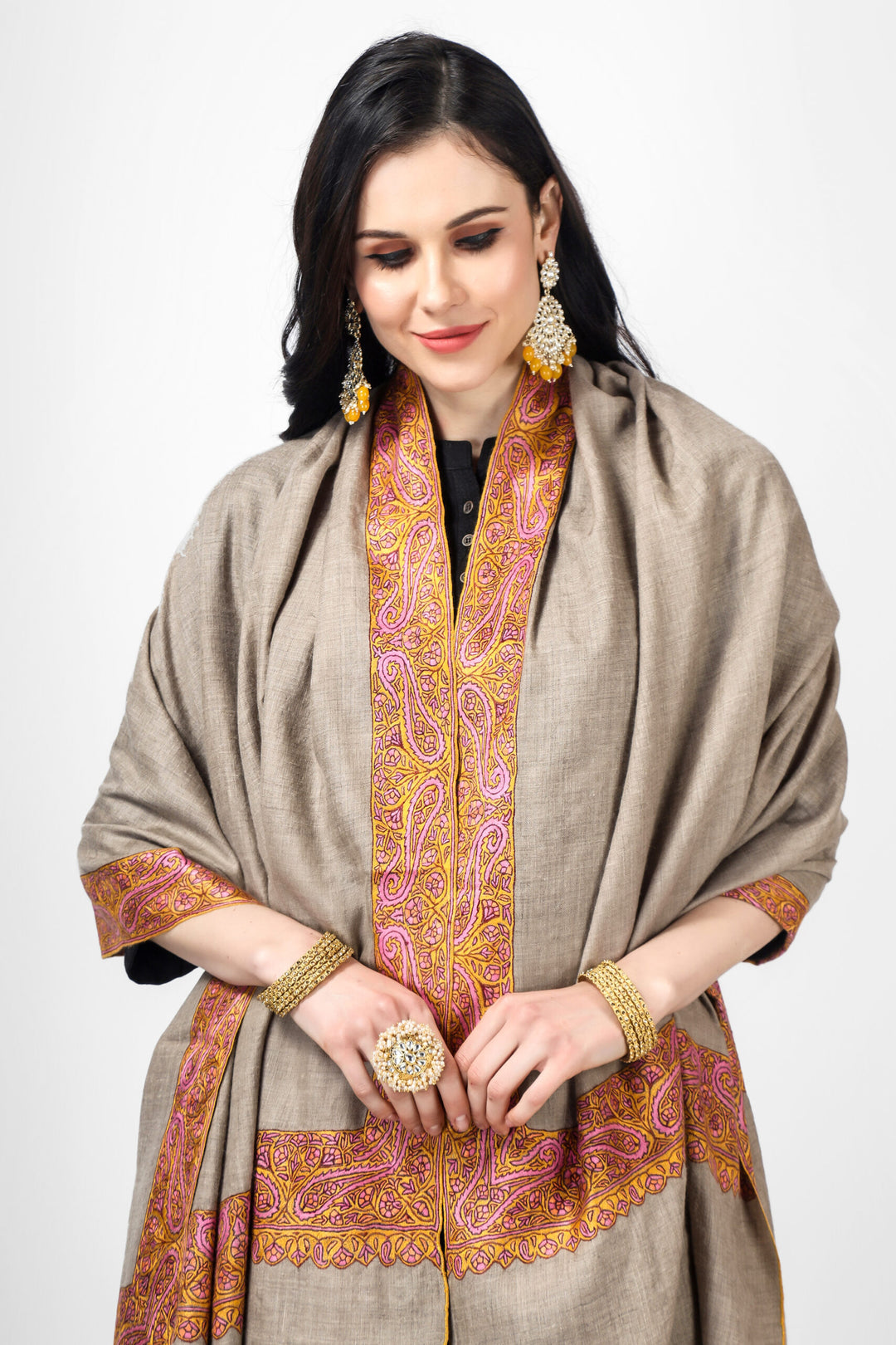 Embrace yourself in luxury with a handcrafted natural  Kashmiri pashmina border shawl. Made from the finest pashmina wool and designed with gorgeous kalaan border needlework, this pashmina shawl will keep you snug and fashionable. The four sides embroidery of a  Pashmina Shawl, also known as the Dordaar design,