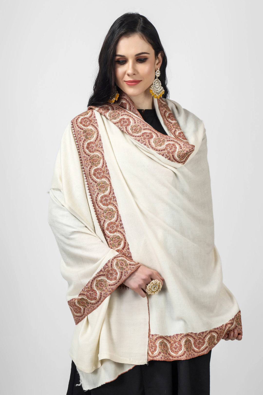 Indulge in opulence with this exquisite off-white handmade Kashmiri pashmina shawl, crafted from the finest pashmina wool, and adorned with an elegant mehraab embroidery design. This designer pashmina shawl is the epitome of luxury, making it the perfect accessory for any occasion, be it a party or a night out.