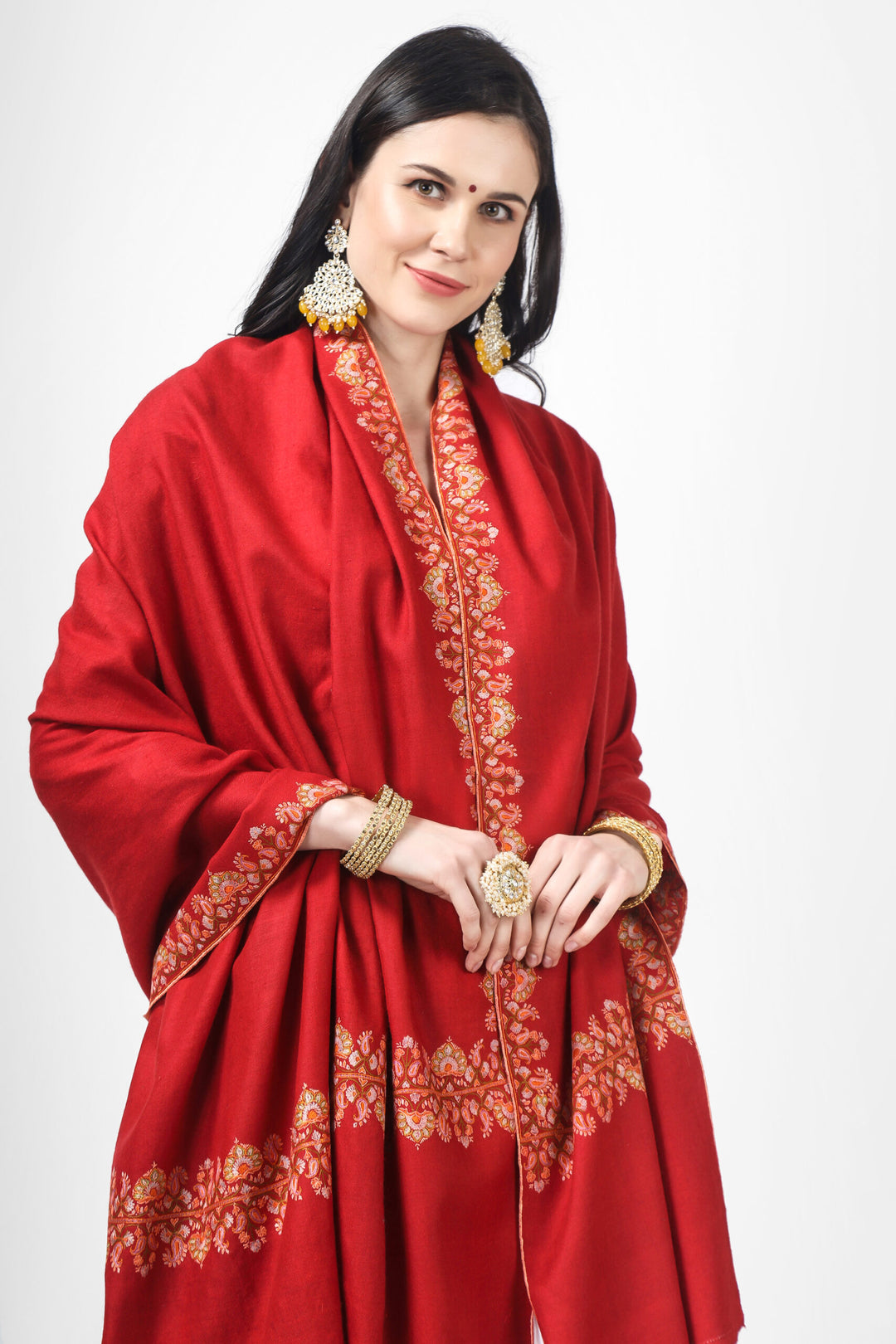 Experience the ultimate in luxury with this red embroidered pashmina shawl Featuring stunning designs and intricate embroidery, our shawls are the perfect accessory for any occasion. Wrap yourself in the unmatched warmth and comfort of our premium quality pashmina wool shawls.