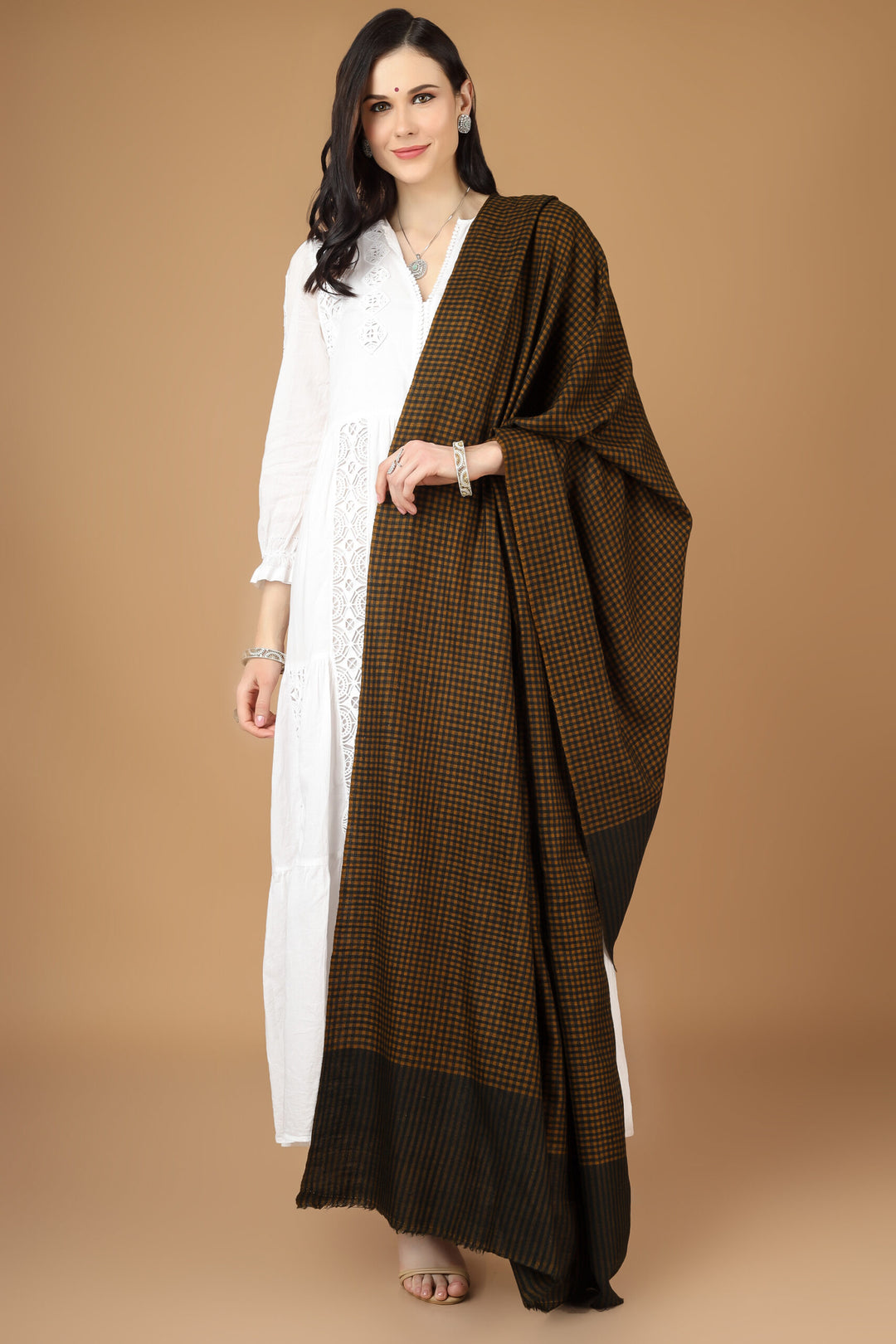 Kashmiri pashmina shawl, which is wonderfully crafted in a multi-check pattern with a blend of yellow and black, you may wrap yourself in luxury. Elegant checks are created by a professional artisan using the finest pashmina , making them the ideal accessory for any event, including weddings and nights out.