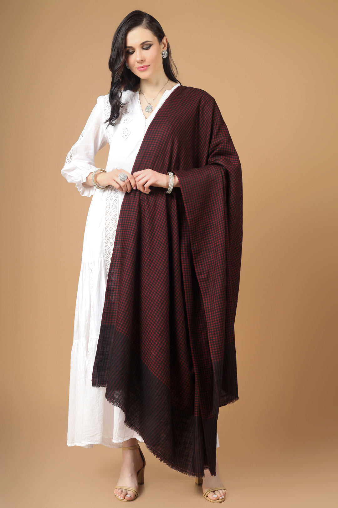 The experienced artisans of Kashmir display their knowledge of exquisite weaving in this subtle and calming checkered Purple Pashmina Shawl. During the harsh winter days, Cashmere's warm hug acts as a fortress. Show off your opulent style to receive compliments in the greatest way possible.