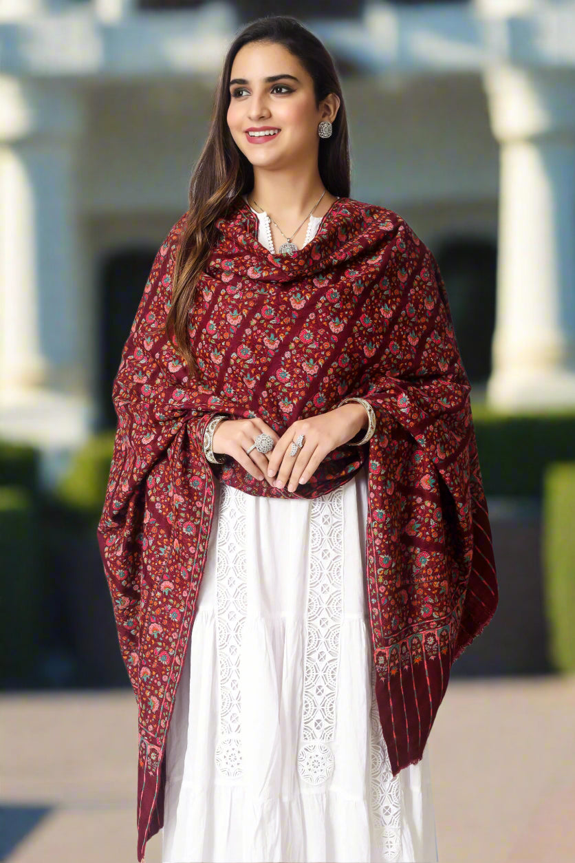 A passionate and ravishing wine color Pashmina Shawl in combination with the legendary paper mache Sozni Embroidery in intricate Jaldaar khatras.