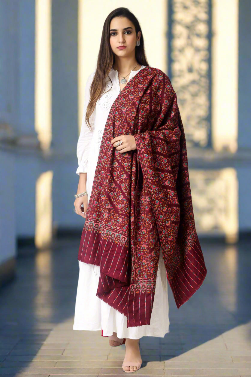 A passionate and ravishing wine color Pashmina Shawl in combination with the legendary paper mache Sozni Embroidery in intricate Jaldaar khatras.