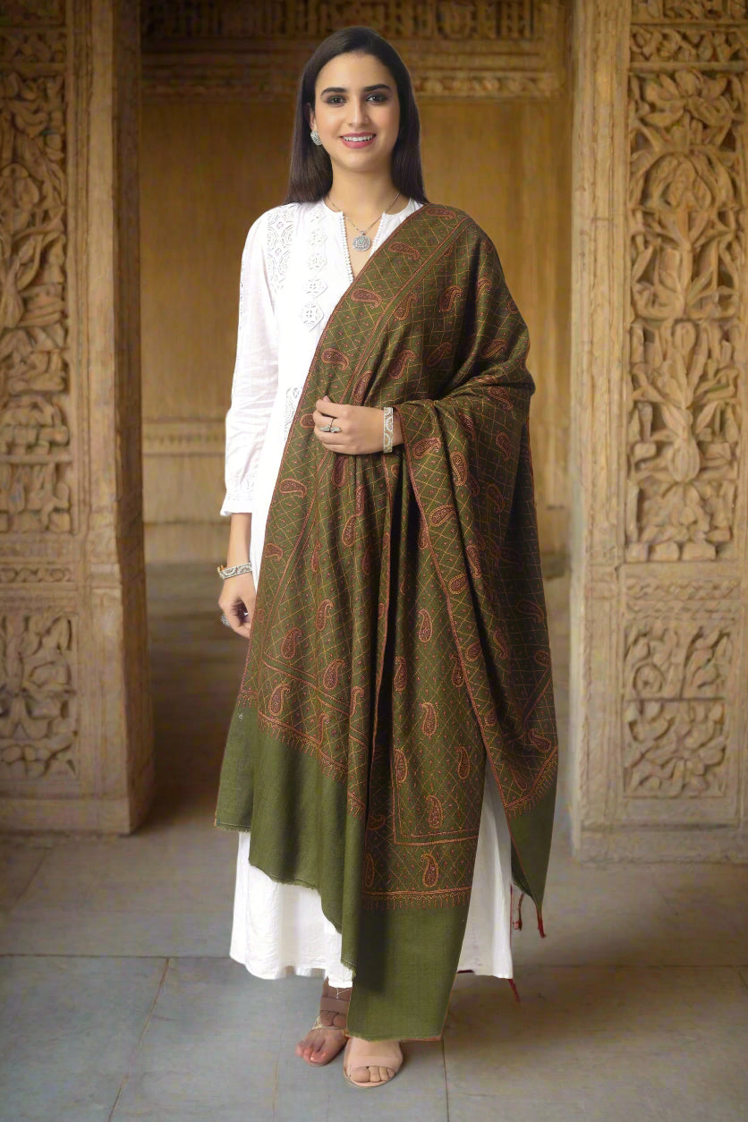 Experience the unparalleled luxury of a handwoven Pashmina shawl with exquisite Sozni embroidery and intricate Jaldaar pattern. This elegant grey shawl is crafted from fine Pashm thread and features charming Sozni threads that span across the surface in symmetrical floral vines. Each piece is artisan-made with exquisite Sozni detailing, making it a truly one-of-a-kind accessory. Shop now for a luxury Pashmina shawl that is sure to elevate any outfit.