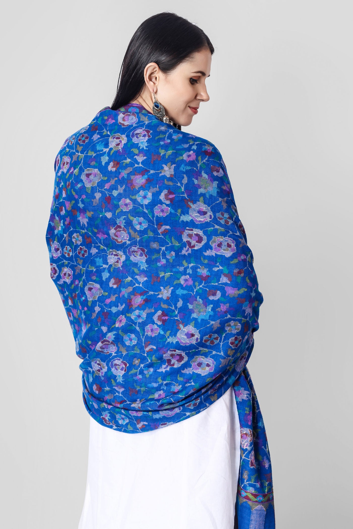 This elegant Blue Pashmina kani shawl features dancing florals and motifs in all the colors of nature skilled in the same splendid Kani weave. 