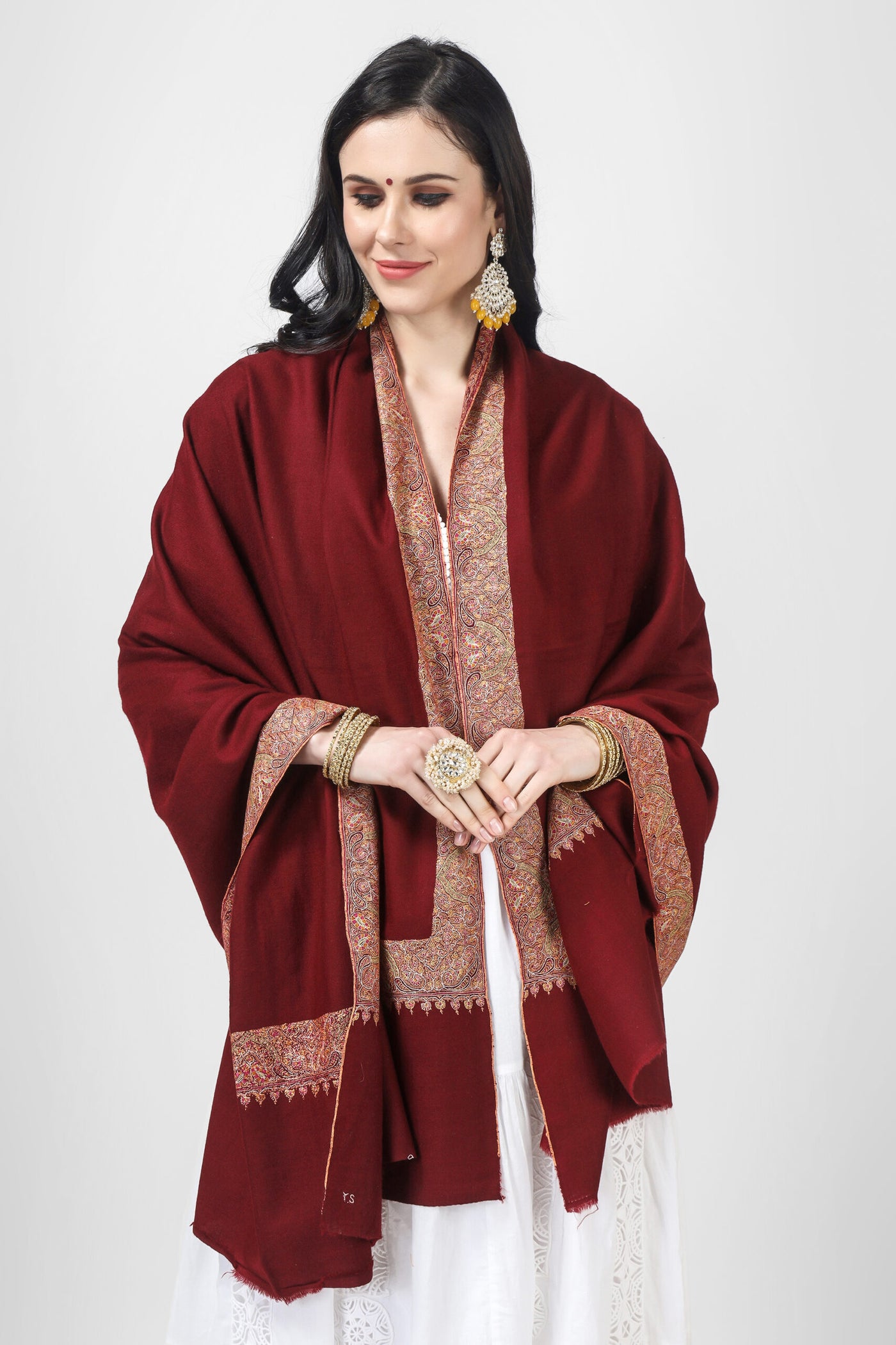 Maroon mehraab Pashmina border sozni shawl expertly crafted from the finest pashmina material and featuring intricate embroidery . Perfect for any occasion, our shawls offer unmatched warmth, comfort, and style. Treat yourself or your loved ones to the ultimate indulgence with our authentic and handwoven shawls.