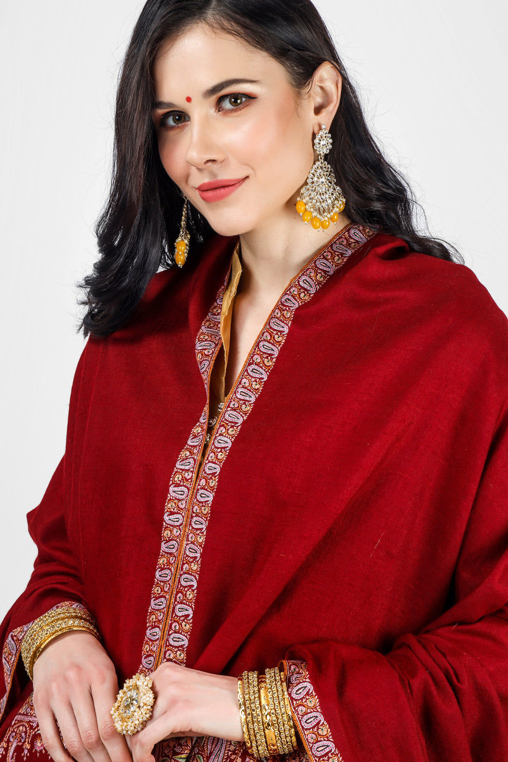 This is a maroon pashmina border shawl embroidered by our expert artisan In our online pashmina shop,