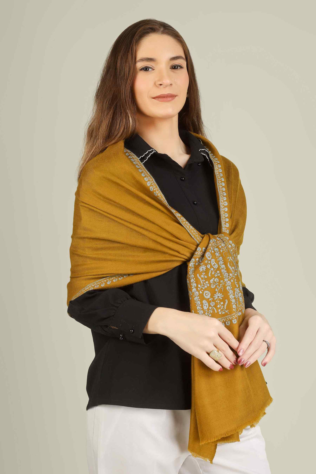 This GI-certified golden pashmina designer paldaar stole is handwoven in Kashmir from the finest pure pashmina, dyed in a deep antique-gold tone that flatters every skin tone