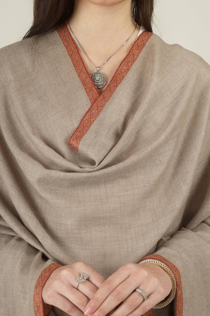 Close-up of the embroidered border on a draped natural Pashmina shawl
    
      | pashmina shawls online | authentic Kashmiri pashmina shawl online | pure pashmina shawl online | original GI certified pashmina shawl online | luxury men's pashmina shawl online from Kashmir | where to buy online pure pashmina in India
    
    | GI Tag Certified - Government-verified authentic Kashmiri Pashmina
    | G20 Official Partner - Selected by India for G20 Summit gifting
    | Handicraft Registered - Official recognition of traditional craftsmanship
    | Certificate of Authenticity - Every purchase includes GI certification