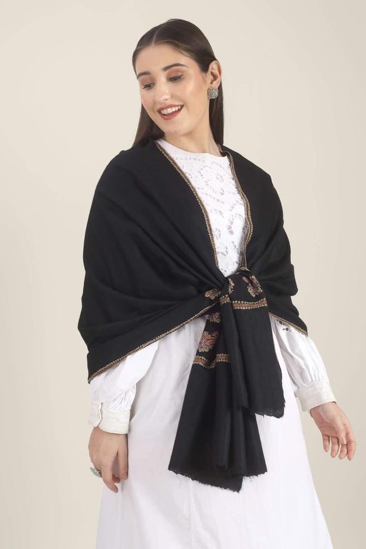 Model wearing a black GI Kashmiri Pure Pashmina stole with multicolour paisley Sozni embroidery on the borders over a white outfit.
    
      | pashmina shawls online | authentic Kashmiri pashmina shawl online | pure pashmina shawl online | original GI certified pashmina shawl online | luxury men's pashmina shawl online from Kashmir | where to buy online pure pashmina in India
    
    | GI Tag Certified - Government-verified authentic Kashmiri Pashmina
    | G20 Official Partner - Selected by India for G20 Summit gifting
    | Handicraft Registered - Official recognition of traditional craftsmanship
    | Certificate of Authenticity - Every purchase includes GI certification