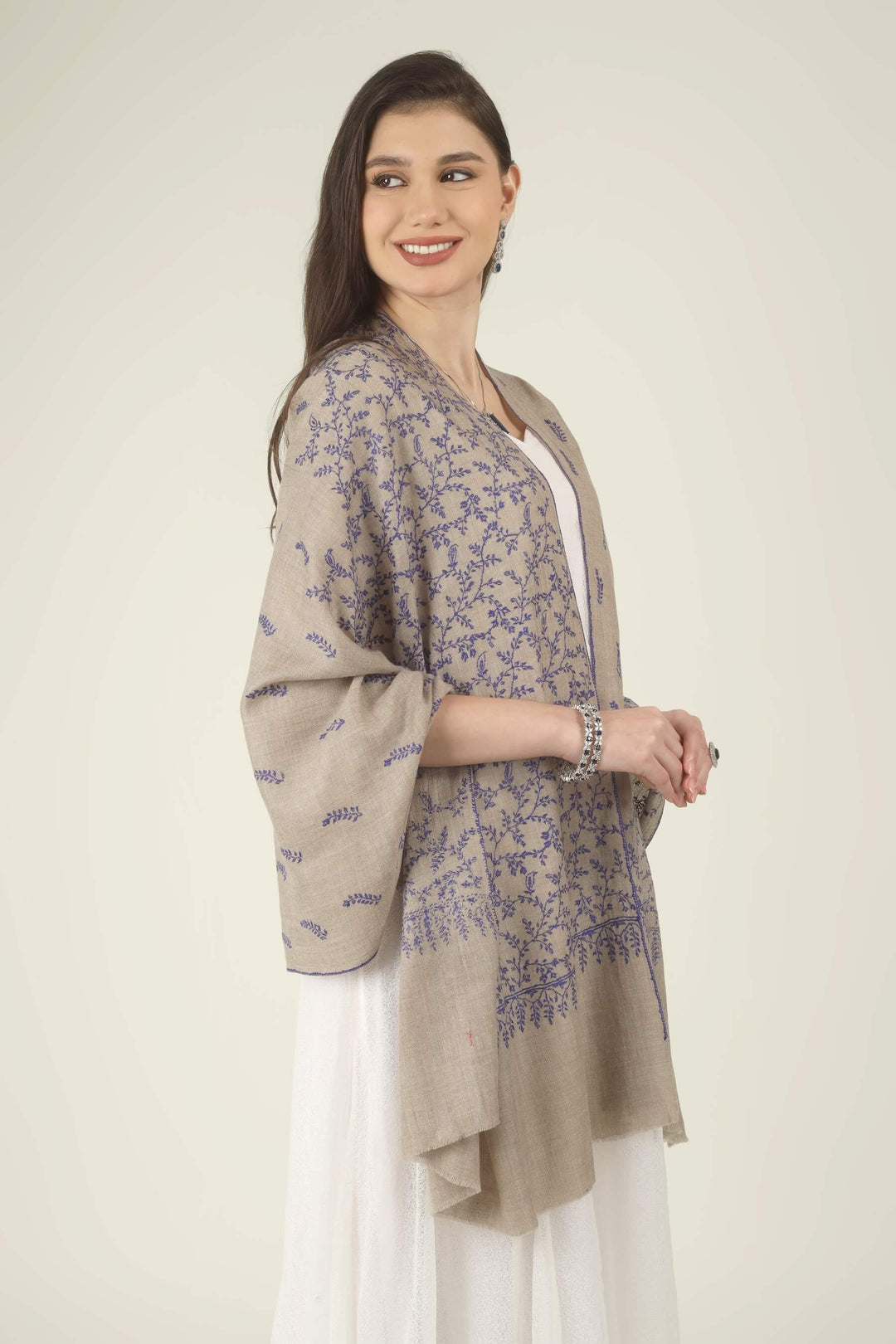 This Beige GI Kashmiri Pure Pashmina Blue Jaal Embroidered Stole features a soft natural beige base covered in fine royal blue floral vines. Delicate leaves, tiny buds and curling tendrils 