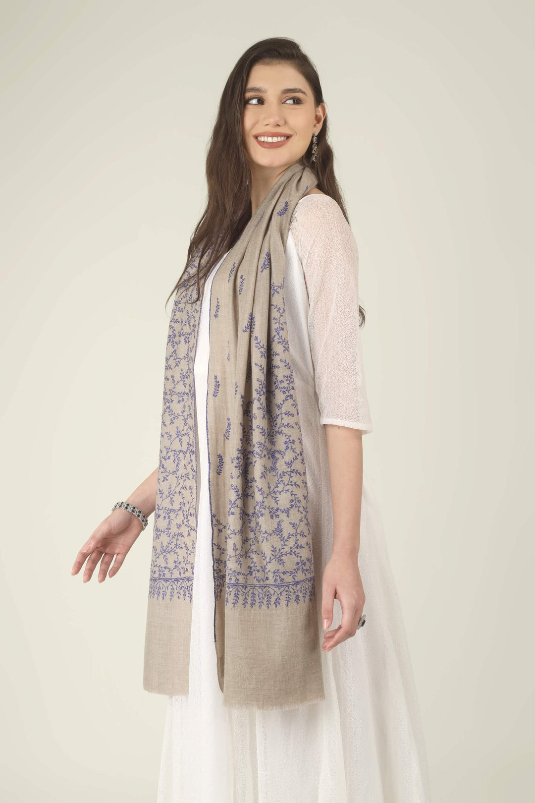This Beige GI Kashmiri Pure Pashmina Blue Jaal Embroidered Stole features a soft natural beige base covered in fine royal blue floral vines. Delicate leaves, tiny buds and curling tendrils 