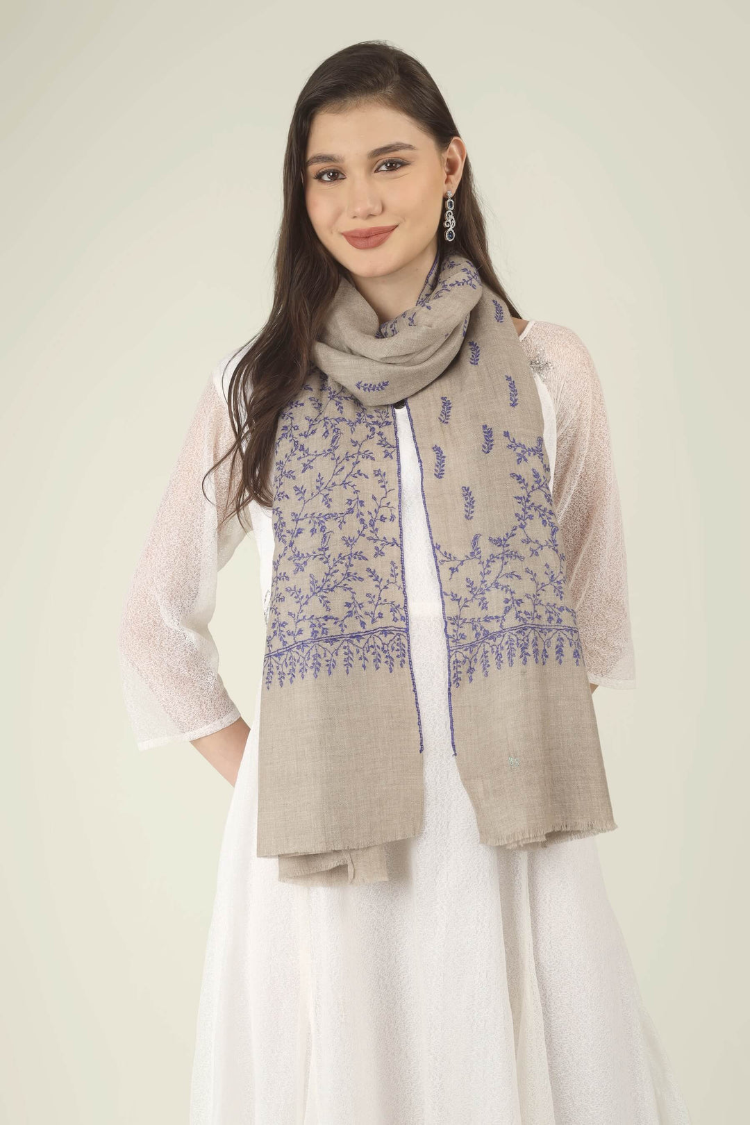 This Beige GI Kashmiri Pure Pashmina Blue Jaal Embroidered Stole features a soft natural beige base covered in fine royal blue floral vines. Delicate leaves, tiny buds and curling tendrils 