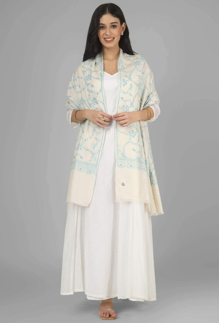 Close-up of a white GI Kashmiri Pure Pashmina stole with delicate sky-blue floral Sozni embroidery draped around the neck.
    
      | pashmina shawls online | authentic Kashmiri pashmina shawl online | pure pashmina shawl online | original GI certified pashmina shawl online | luxury men's pashmina shawl online from Kashmir | where to buy online pure pashmina in India
    
    | GI Tag Certified - Government-verified authentic Kashmiri Pashmina
    | G20 Official Partner - Selected by India for G20 Summit gifting
    | Handicraft Registered - Official recognition of traditional craftsmanship
    | Certificate of Authenticity - Every purchase includes GI certification