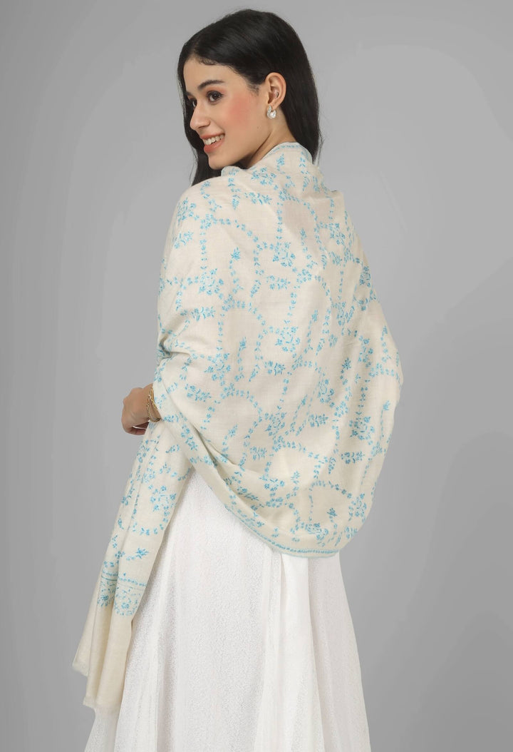 Close-up of a white GI Kashmiri Pure Pashmina stole with delicate sky-blue floral Sozni embroidery draped around the neck.
    
      | pashmina shawls online | authentic Kashmiri pashmina shawl online | pure pashmina shawl online | original GI certified pashmina shawl online | luxury men's pashmina shawl online from Kashmir | where to buy online pure pashmina in India
    
    | GI Tag Certified - Government-verified authentic Kashmiri Pashmina
    | G20 Official Partner - Selected by India for G20 Summit gifting
    | Handicraft Registered - Official recognition of traditional craftsmanship
    | Certificate of Authenticity - Every purchase includes GI certification