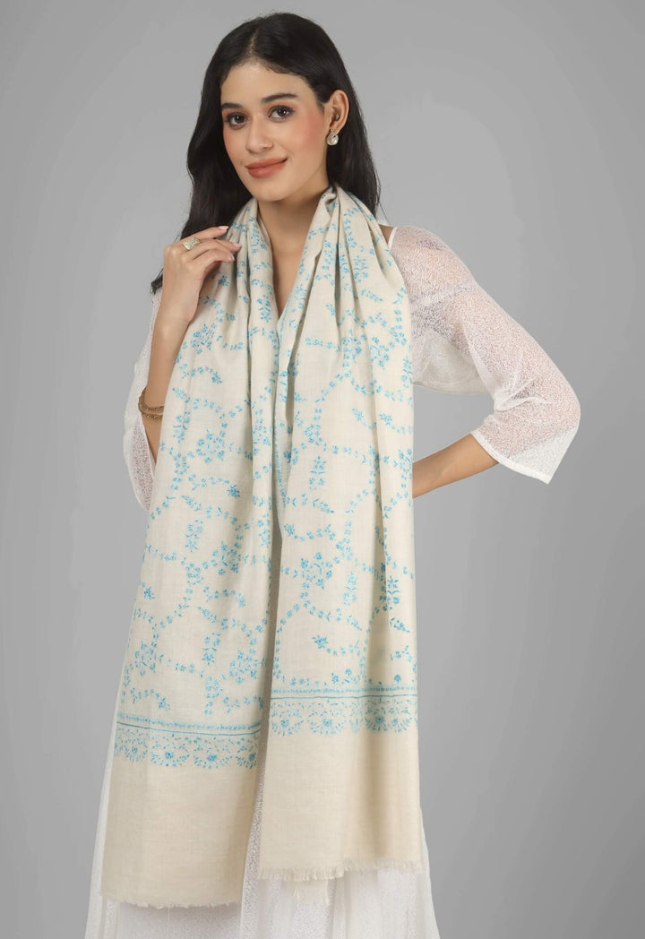 Close-up of a white GI Kashmiri Pure Pashmina stole with delicate sky-blue floral Sozni embroidery draped around the neck.
    
      | pashmina shawls online | authentic Kashmiri pashmina shawl online | pure pashmina shawl online | original GI certified pashmina shawl online | luxury men's pashmina shawl online from Kashmir | where to buy online pure pashmina in India
    
    | GI Tag Certified - Government-verified authentic Kashmiri Pashmina
    | G20 Official Partner - Selected by India for G20 Summit gifting
    | Handicraft Registered - Official recognition of traditional craftsmanship
    | Certificate of Authenticity - Every purchase includes GI certification