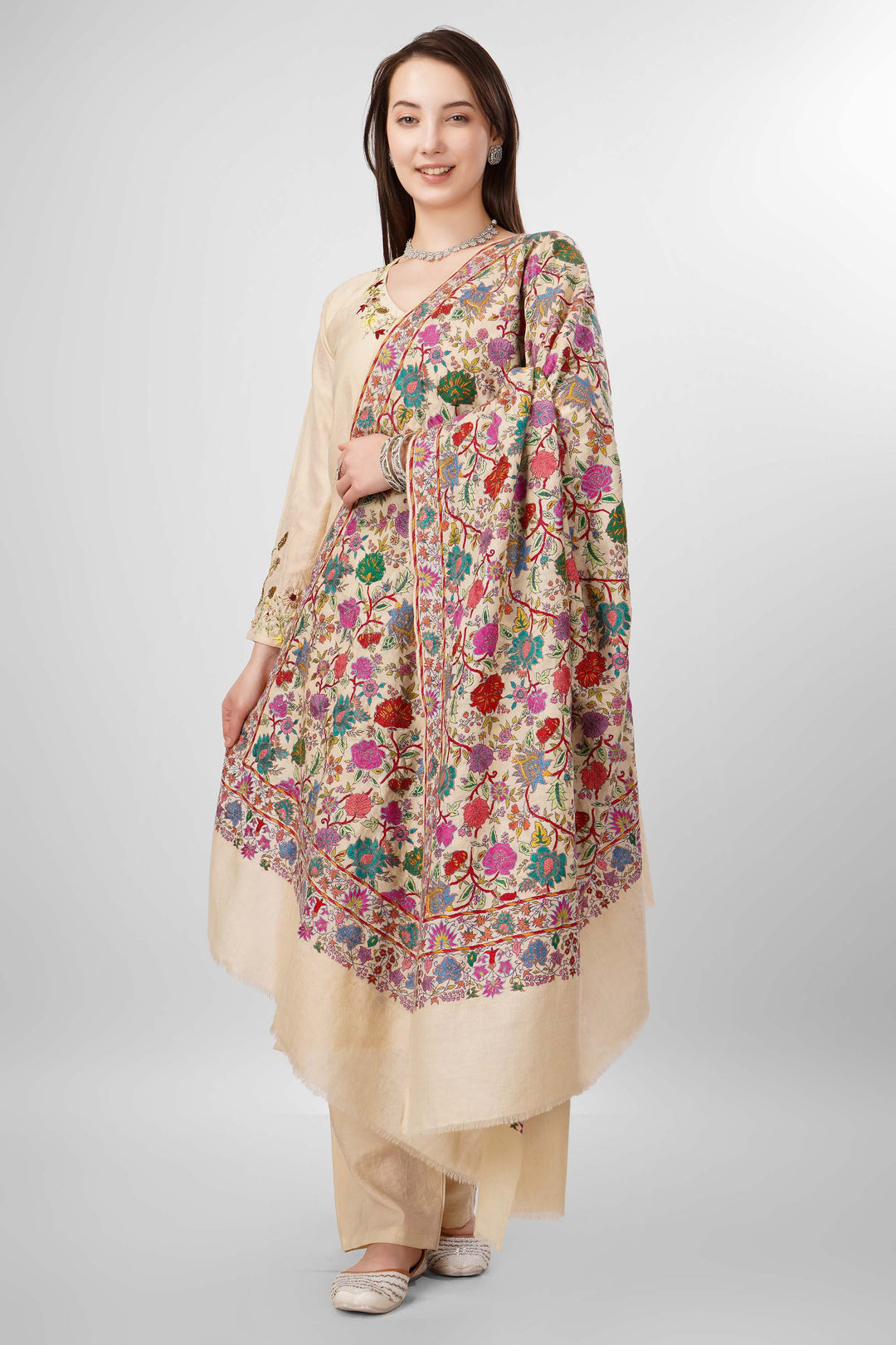 White Sozni Jama Pashmina Shawls Online – Artistry in Multicolor Floral Finesse
   The Pashmina White Sozni Malaika Ruqaiya Jama Shawl is a dazzling instance of Kashmiri handwoven royalty. Spun from premium pure pashmina, this shawl features a pristine ivory-white base enveloped in flamboyant allover sozni embroidery