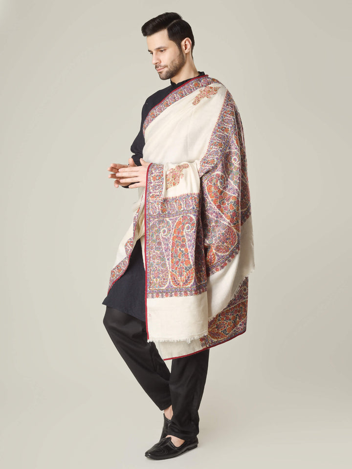 Antique Kashmiri kalamkari sozni men’s shawl with intricate multicolour paisley and floral embroidery on ivory pashmina, draped over a black kurta, handcrafted luxury wedding shawl from Kashmir.
    
      | pashmina shawls online | authentic Kashmiri pashmina shawl online | pure pashmina shawl online | original GI certified pashmina shawl online | luxury men's pashmina shawl online from Kashmir | where to buy online pure pashmina in India
    
    | GI Tag Certified - Government-verified authentic Kashmiri Pashmina
    | G20 Official Partner - Selected by India for G20 Summit gifting
    | Handicraft Registered - Official recognition of traditional craftsmanship
    | Certificate of Authenticity - Every purchase includes GI certification