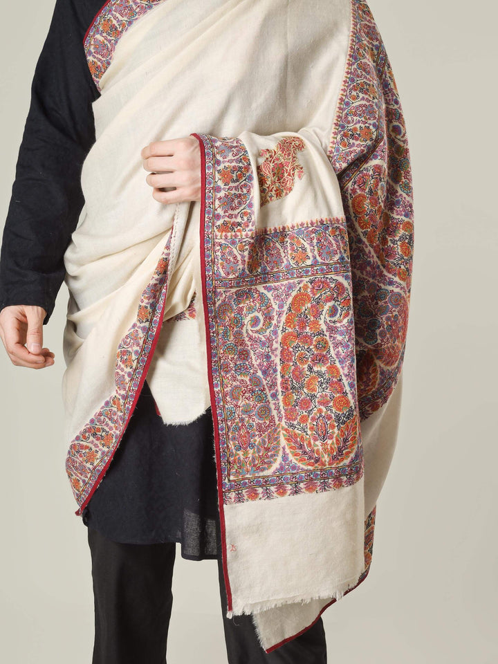 Antique Kashmiri kalamkari sozni men’s shawl with intricate multicolour paisley and floral embroidery on ivory pashmina, draped over a black kurta, handcrafted luxury wedding shawl from Kashmir.
    
      | pashmina shawls online | authentic Kashmiri pashmina shawl online | pure pashmina shawl online | original GI certified pashmina shawl online | luxury men's pashmina shawl online from Kashmir | where to buy online pure pashmina in India
    
    | GI Tag Certified - Government-verified authentic Kashmiri Pashmina
    | G20 Official Partner - Selected by India for G20 Summit gifting
    | Handicraft Registered - Official recognition of traditional craftsmanship
    | Certificate of Authenticity - Every purchase includes GI certification