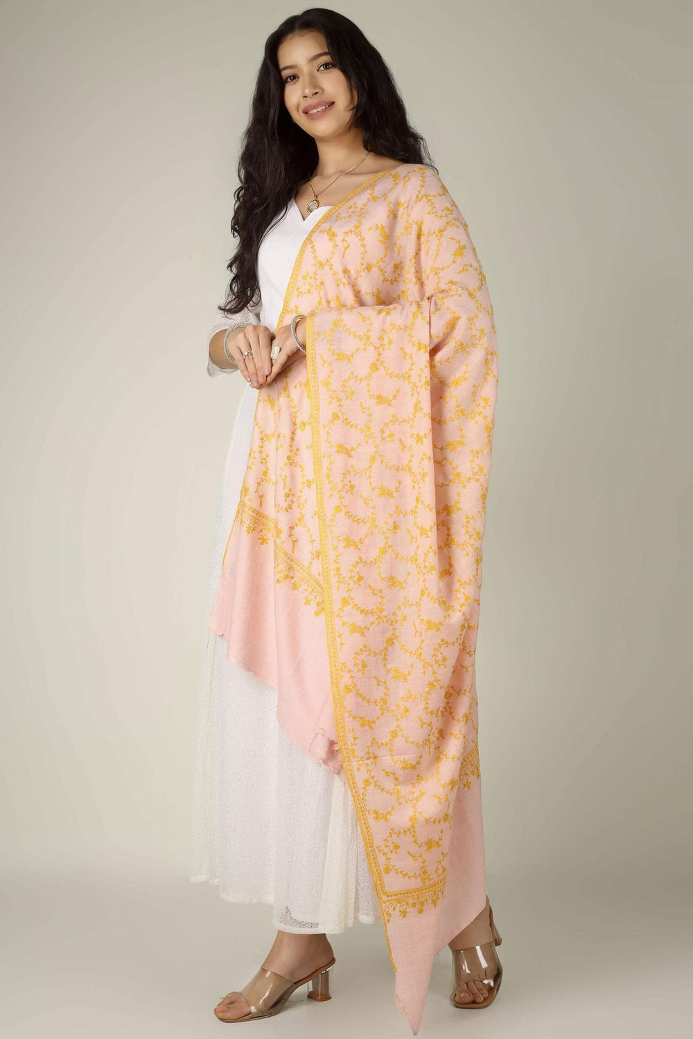 The Light Pink Pashmina Jaldaar Shawl by Kepra is a breathtaking example of Kashmiri luxury, combining the ethereal softness of authentic high-altitude Pashmina wool with the opulence of traditional Jaldaar embroidery