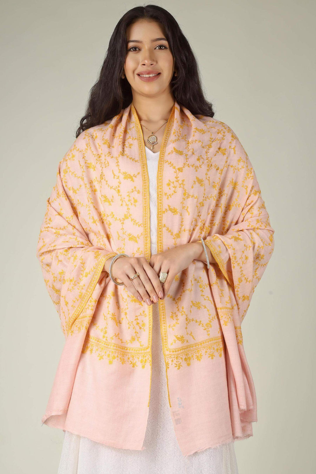 The Light Pink Pashmina Jaldaar Shawl by Kepra is a breathtaking example of Kashmiri luxury, combining the ethereal softness of authentic high-altitude Pashmina wool with the opulence of traditional Jaldaar embroidery