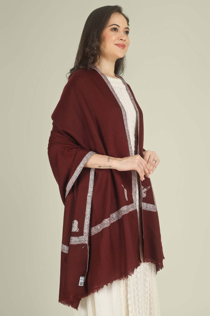 A woman wearing a deep maroon shawl with silver embroidered borders over a white dress, standing against a solid light beige background.
    
      | pashmina shawls online | authentic Kashmiri pashmina shawl online | pure pashmina shawl online | original GI certified pashmina shawl online | luxury men's pashmina shawl online from Kashmir | where to buy online pure pashmina in India
    
    | GI Tag Certified - Government-verified authentic Kashmiri Pashmina
    | G20 Official Partner - Selected by India for G20 Summit gifting
    | Handicraft Registered - Official recognition of traditional craftsmanship
    | Certificate of Authenticity - Every purchase includes GI certification