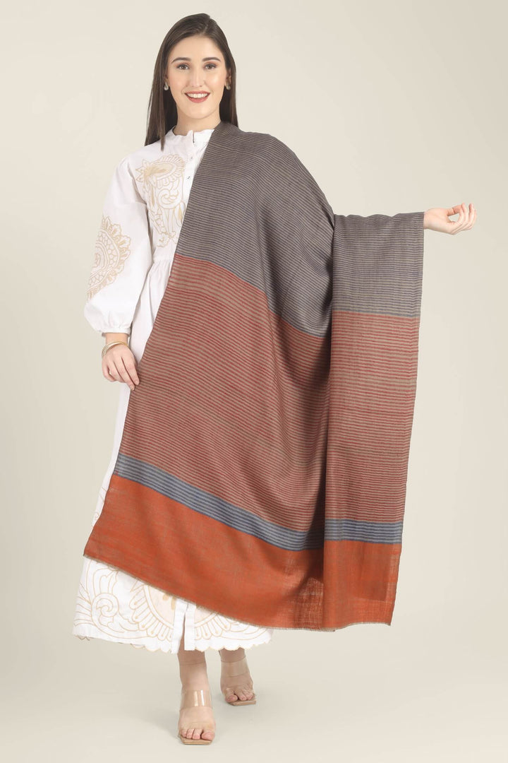 Model draped in a multicolour Pure Kashmiri Pashmina shawl with woven grey-blue, rust-red and taupe stripes and a wide plain rust border over a white embroidered dress.
    
      | pashmina shawls online | authentic Kashmiri pashmina shawl online | pure pashmina shawl online | original GI certified pashmina shawl online | luxury men's pashmina shawl online from Kashmir | where to buy online pure pashmina in India
    
    | GI Tag Certified - Government-verified authentic Kashmiri Pashmina
    | G20 Official Partner - Selected by India for G20 Summit gifting
    | Handicraft Registered - Official recognition of traditional craftsmanship
    | Certificate of Authenticity - Every purchase includes GI certification