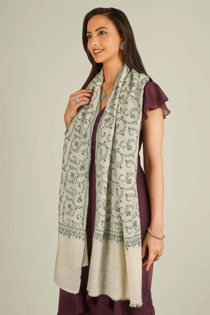 Ivory Kashmiri pure pashmina embroidered stole with green vine motifs by Kepra, wrapped around neck over plum dress, front detail view for Barcelona winter styling
    
      | pashmina shawls online | authentic Kashmiri pashmina shawl online | pure pashmina shawl online | original GI certified pashmina shawl online | luxury men's pashmina shawl online from Kashmir | where to buy online pure pashmina in India
    
    | GI Tag Certified - Government-verified authentic Kashmiri Pashmina
    | G20 Official Partner - Selected by India for G20 Summit gifting
    | Handicraft Registered - Official recognition of traditional craftsmanship
    | Certificate of Authenticity - Every purchase includes GI certification