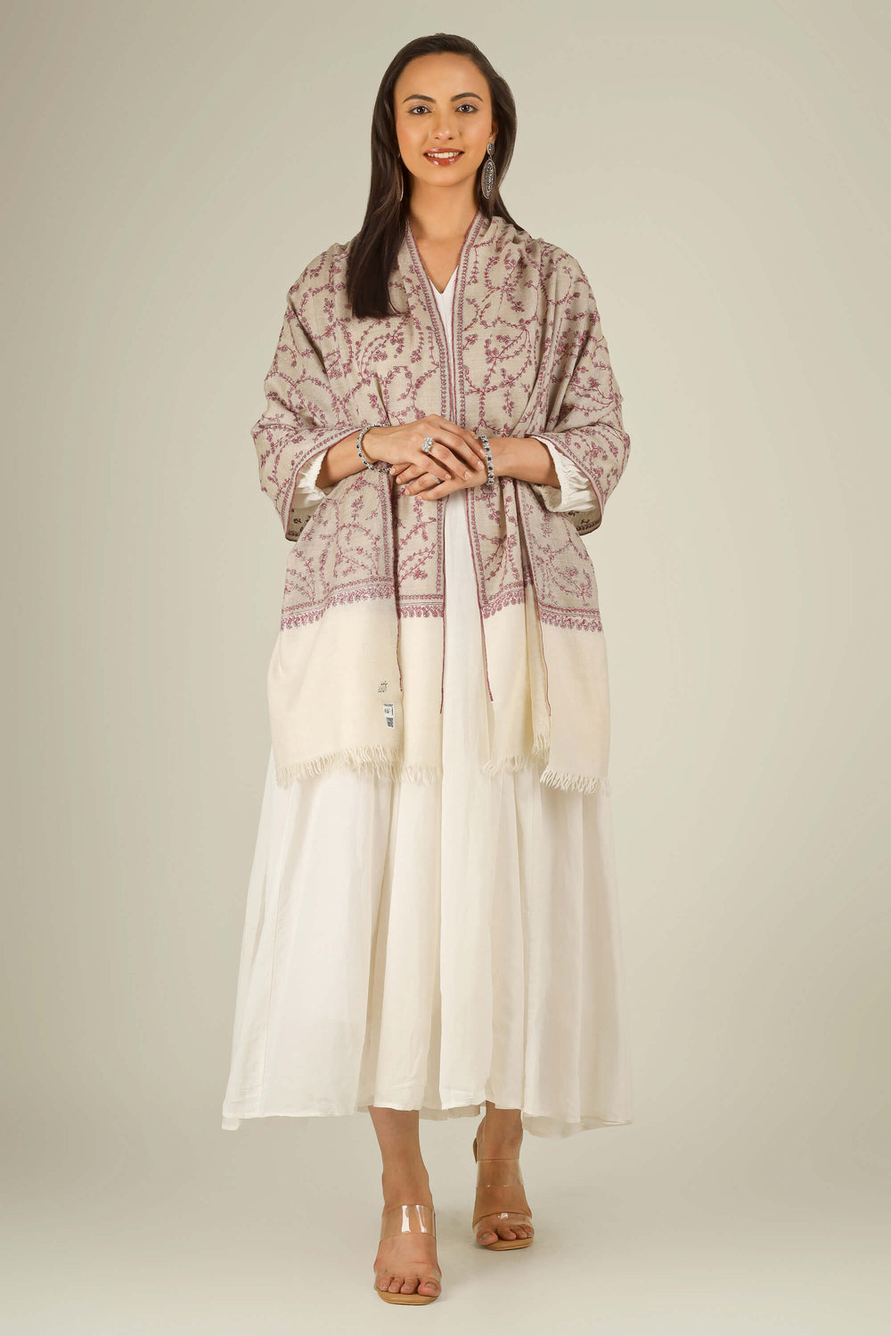 Close-up of beige Kashmiri pure pashmina stole with red sozni vine embroidery, held at the front, detail view for Berlin winter styling
