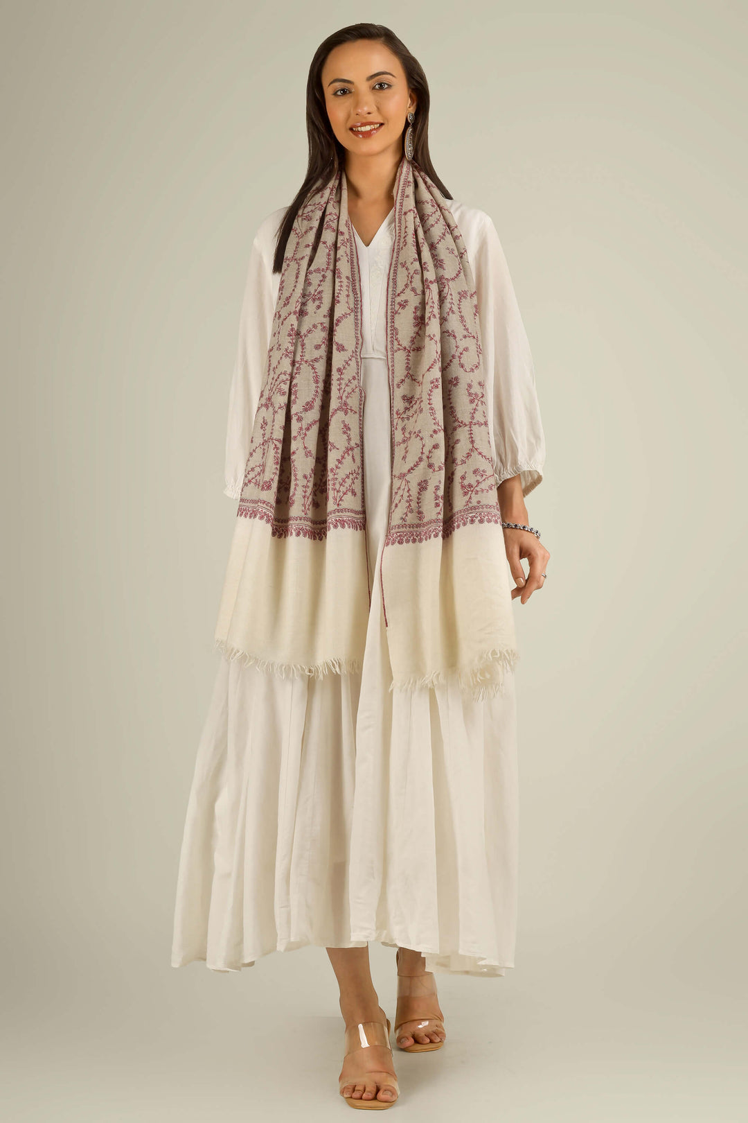 Close-up of beige Kashmiri pure pashmina stole with red sozni vine embroidery, held at the front, detail view for Berlin winter styling