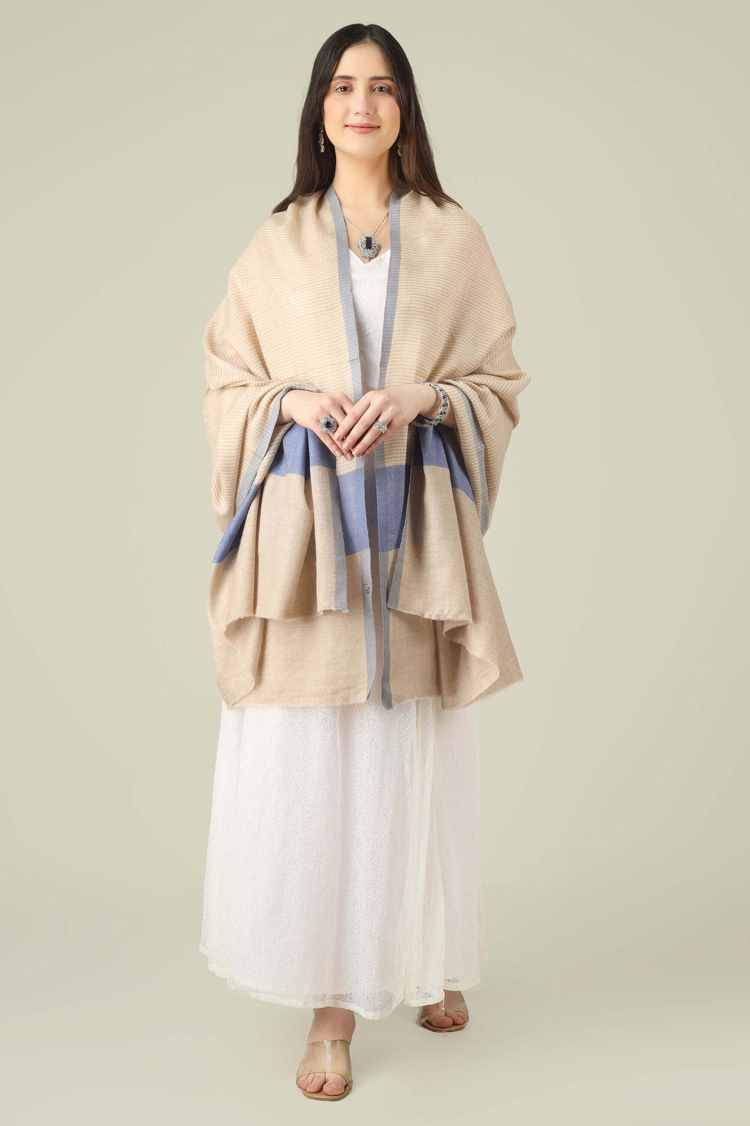 pure pashmina shawl online in India, this natural-beige piece is a wardrobe staple that works just as well with ethnic suits and saris as it does with dresses and denim.