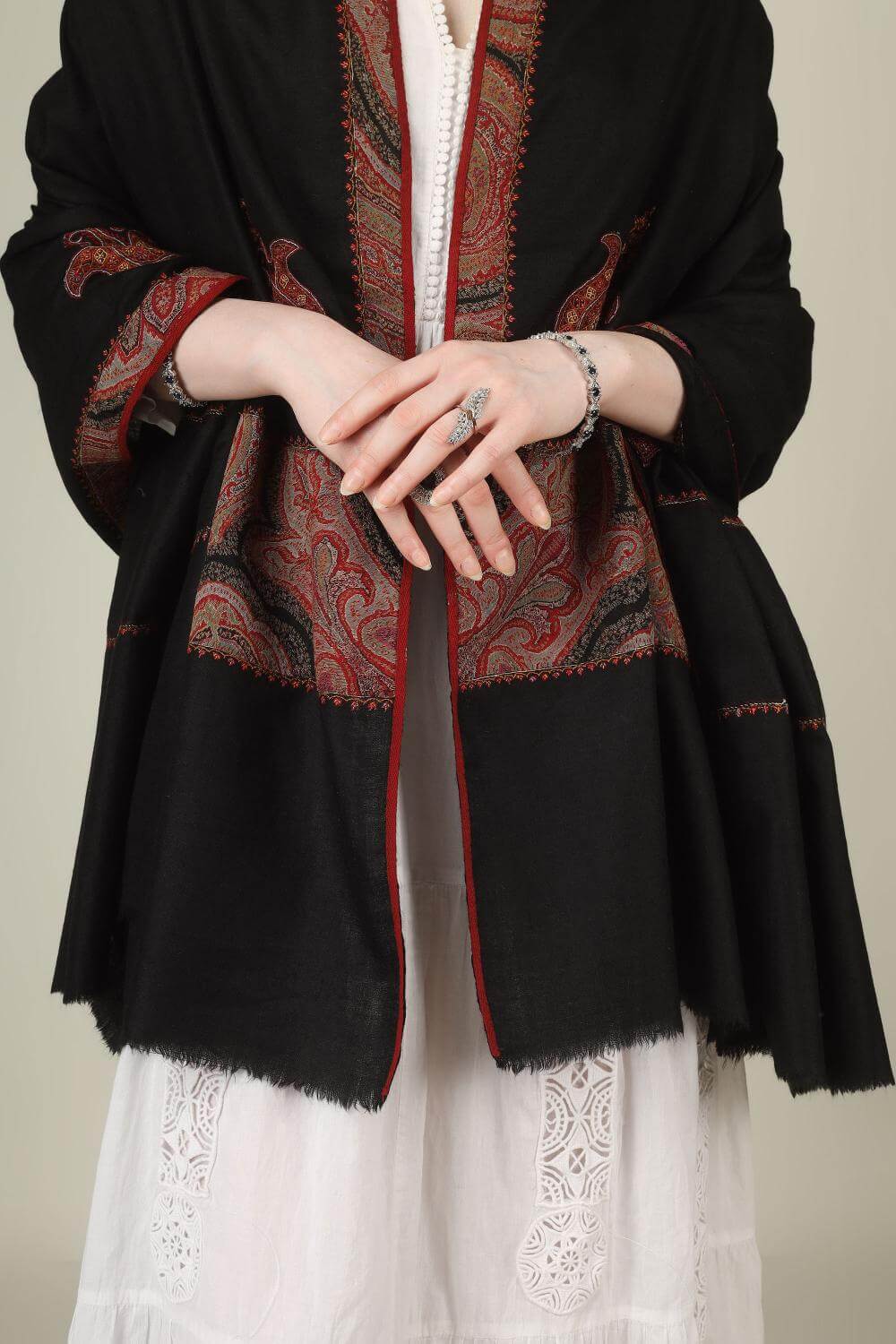 This black pure pashmina shawl is finished with an authentic antique jamawar border, carefully rescued from an old Kashmiri shawl and hand‑patched onto a freshly woven base.
