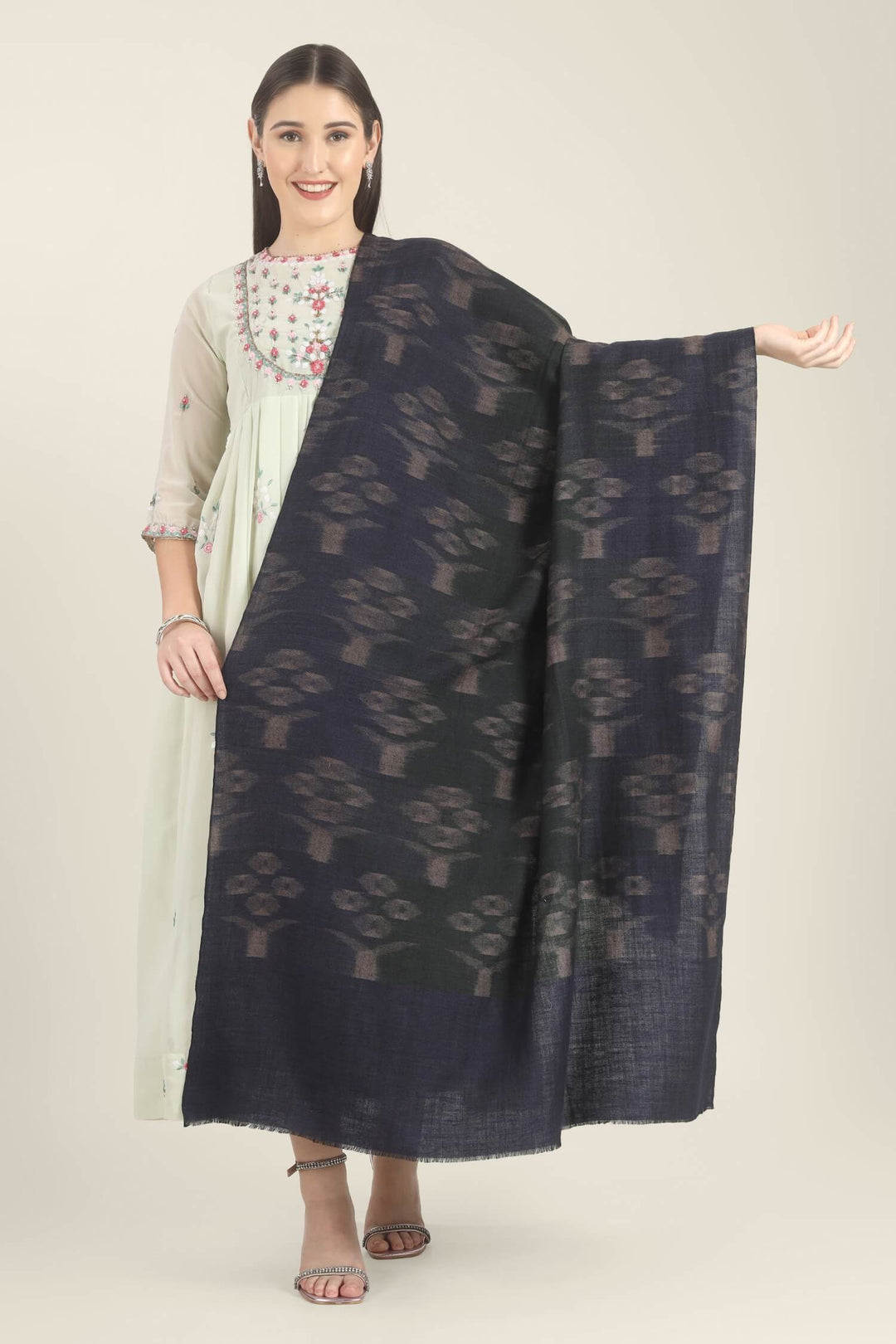 Model draped in a navy Pure Kashmiri Pashmina shawl with woven dusty mauve floral motifs over a pale green embroidered dress.