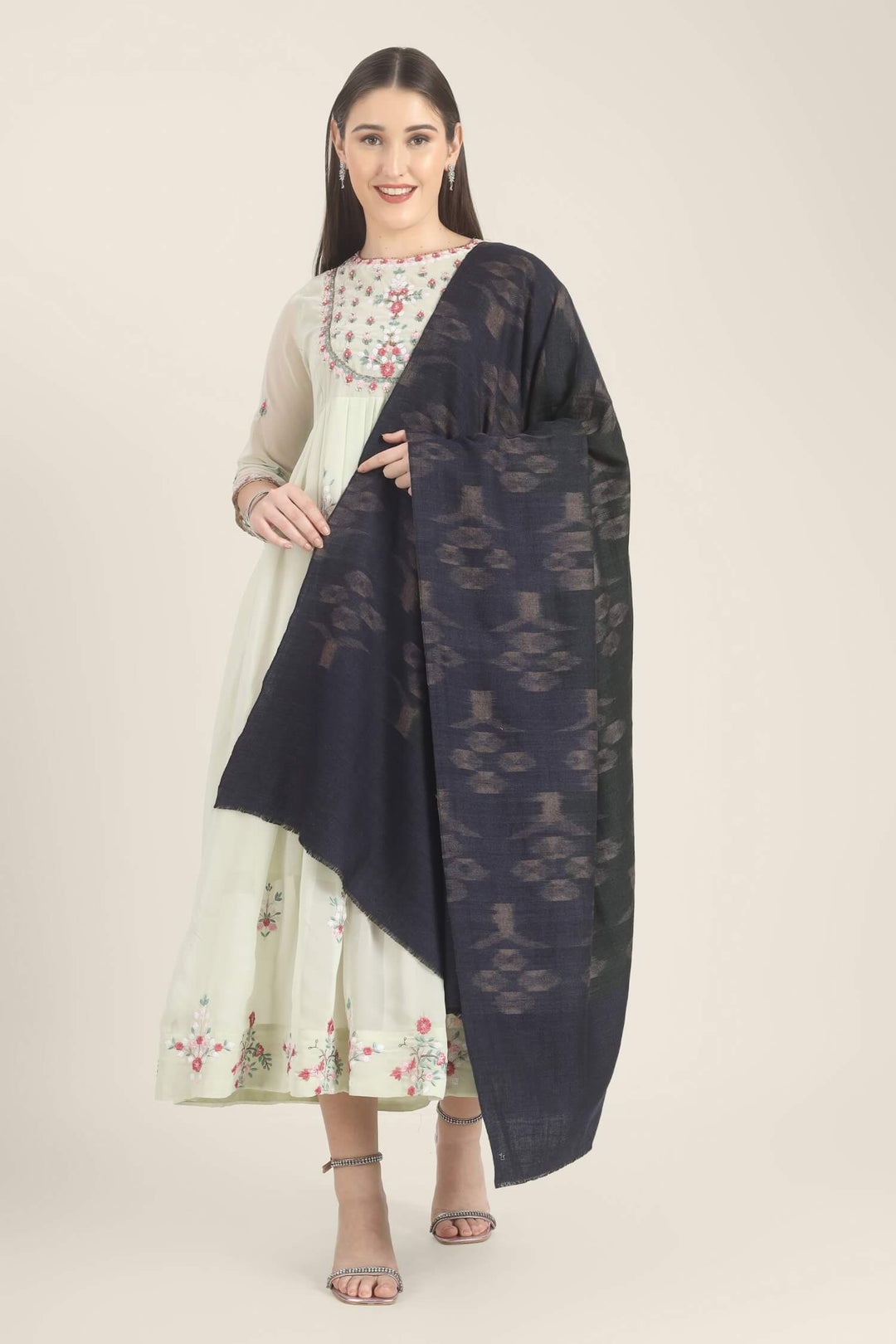 Model draped in a navy Pure Kashmiri Pashmina shawl with woven dusty mauve floral motifs over a pale green embroidered dress.