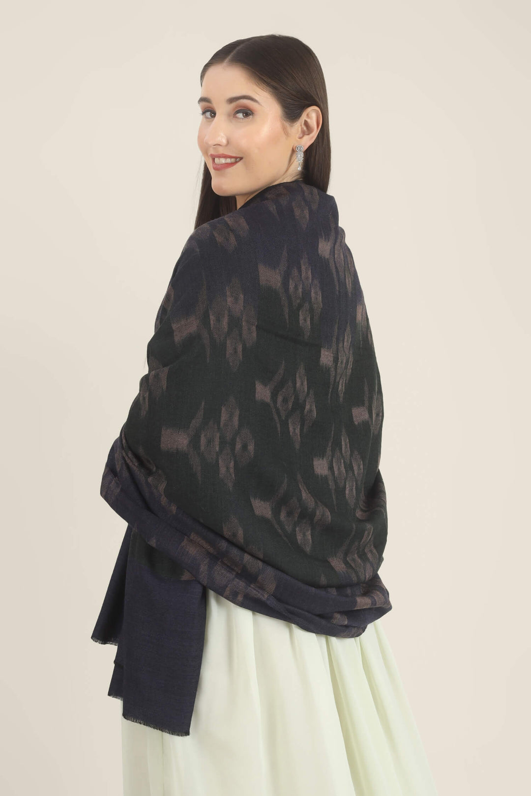 Model draped in a navy Pure Kashmiri Pashmina shawl with woven dusty mauve floral motifs over a pale green embroidered dress.