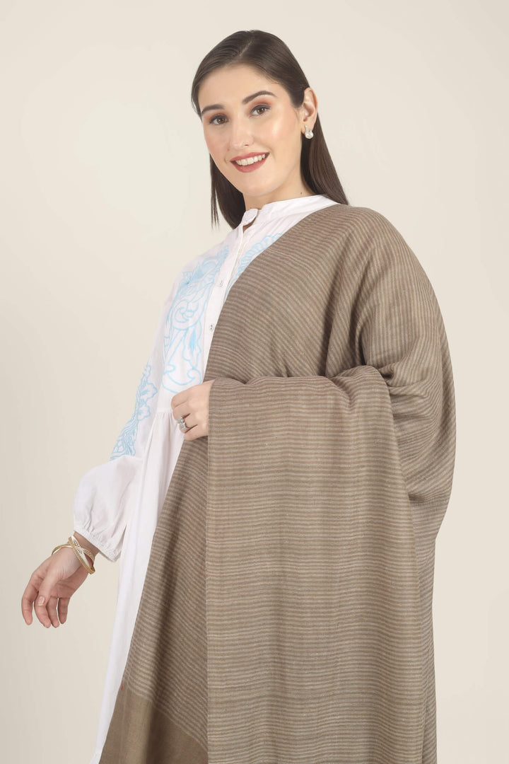 Model draped in a taupe Pure Kashmiri Pashmina shawl with fine woven pinstripes and a wide plain border over a white dress with light blue embroidery.
    
      | pashmina shawls online | authentic Kashmiri pashmina shawl online | pure pashmina shawl online | original GI certified pashmina shawl online | luxury men's pashmina shawl online from Kashmir | where to buy online pure pashmina in India
    
    | GI Tag Certified - Government-verified authentic Kashmiri Pashmina
    | G20 Official Partner - Selected by India for G20 Summit gifting
    | Handicraft Registered - Official recognition of traditional craftsmanship
    | Certificate of Authenticity - Every purchase includes GI certification