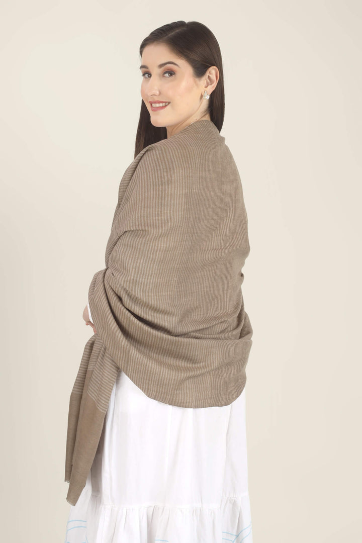 Model draped in a taupe Pure Kashmiri Pashmina shawl with fine woven pinstripes and a wide plain border over a white dress with light blue embroidery.
    
      | pashmina shawls online | authentic Kashmiri pashmina shawl online | pure pashmina shawl online | original GI certified pashmina shawl online | luxury men's pashmina shawl online from Kashmir | where to buy online pure pashmina in India
    
    | GI Tag Certified - Government-verified authentic Kashmiri Pashmina
    | G20 Official Partner - Selected by India for G20 Summit gifting
    | Handicraft Registered - Official recognition of traditional craftsmanship
    | Certificate of Authenticity - Every purchase includes GI certification