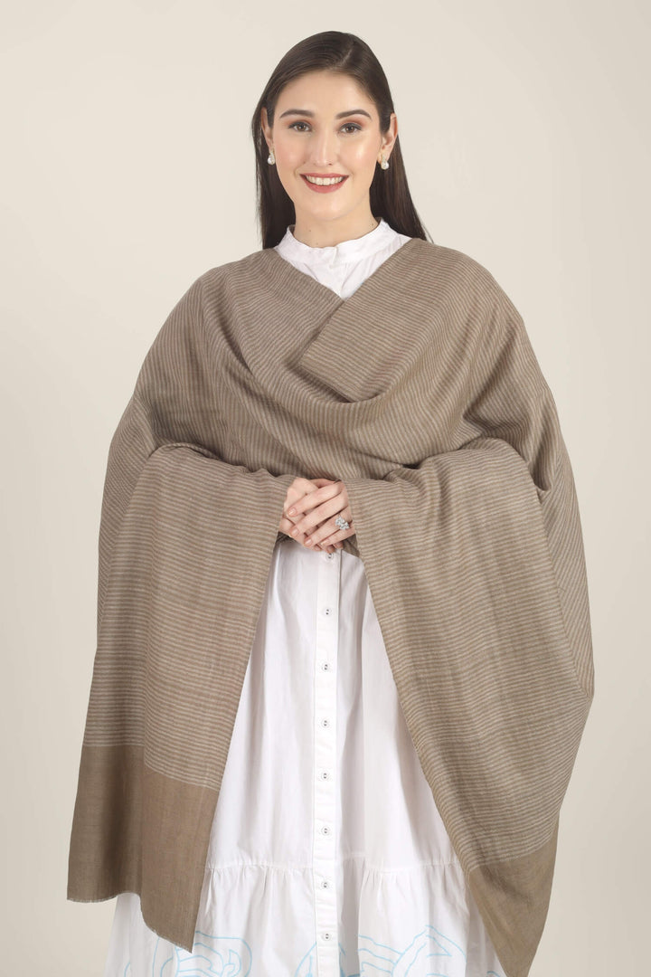 Model draped in a taupe Pure Kashmiri Pashmina shawl with fine woven pinstripes and a wide plain border over a white dress with light blue embroidery.
    
      | pashmina shawls online | authentic Kashmiri pashmina shawl online | pure pashmina shawl online | original GI certified pashmina shawl online | luxury men's pashmina shawl online from Kashmir | where to buy online pure pashmina in India
    
    | GI Tag Certified - Government-verified authentic Kashmiri Pashmina
    | G20 Official Partner - Selected by India for G20 Summit gifting
    | Handicraft Registered - Official recognition of traditional craftsmanship
    | Certificate of Authenticity - Every purchase includes GI certification