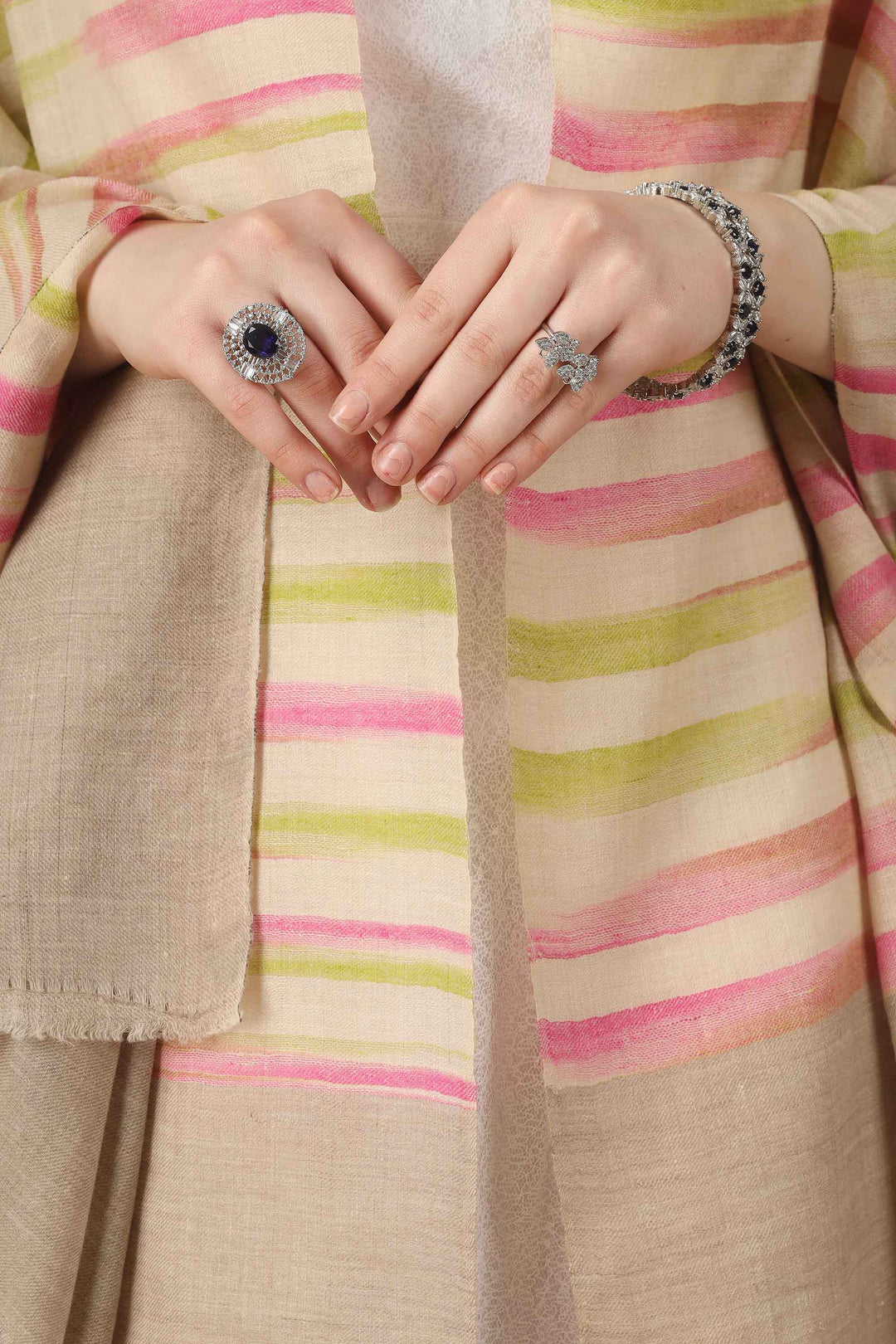 This pure pashmina shawl features a natural beige base scattered with fine horizontal stripes in blush pink, peach, and soft lime