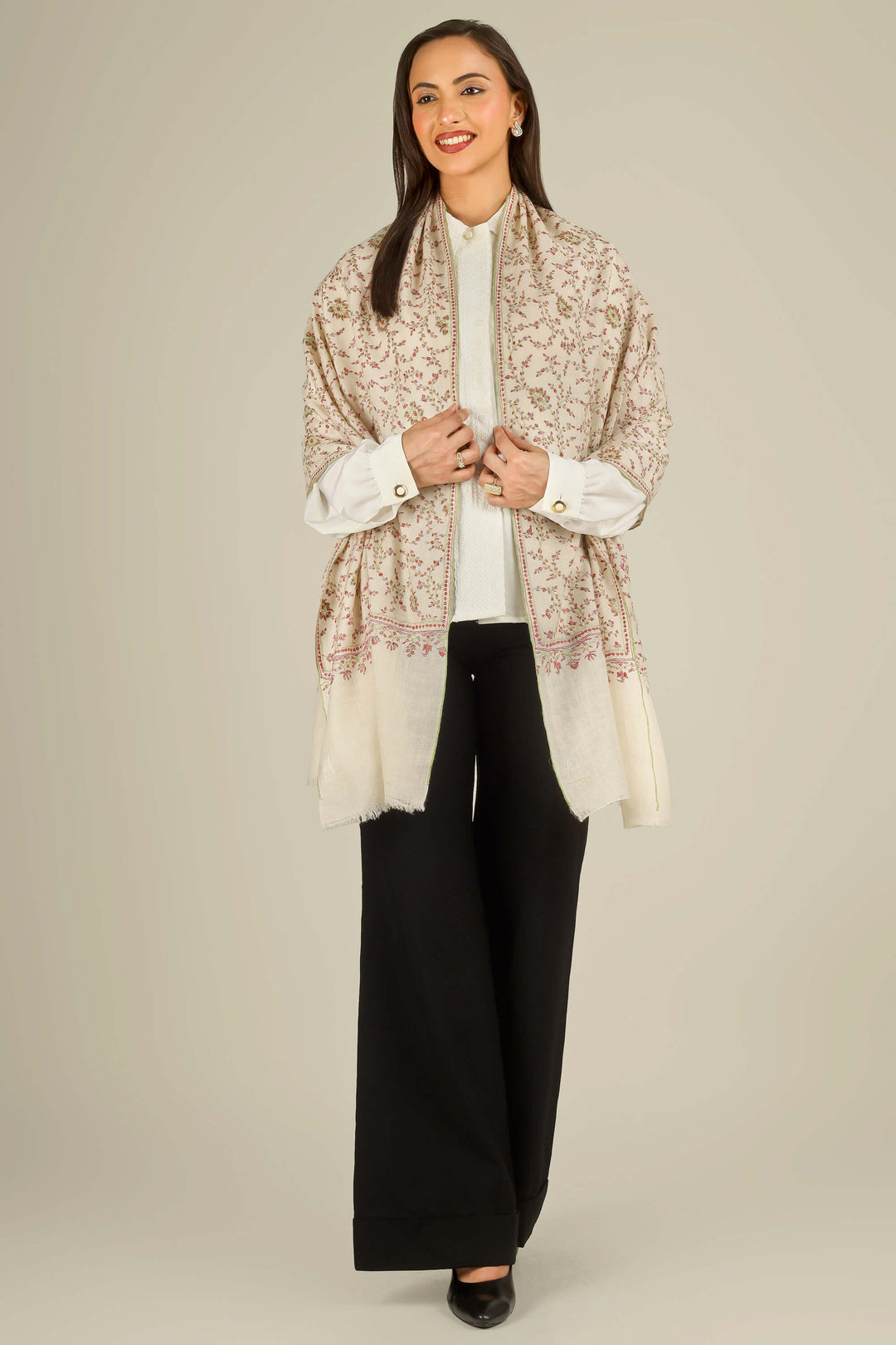 GI cream Kashmiri pure pashmina embroidered stole by Kepra, worn over white shirt and black trousers on smiling model, front view