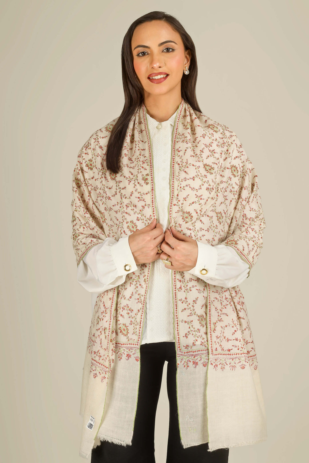 GI cream Kashmiri pure pashmina embroidered stole by Kepra, worn over white shirt and black trousers on smiling model, front view