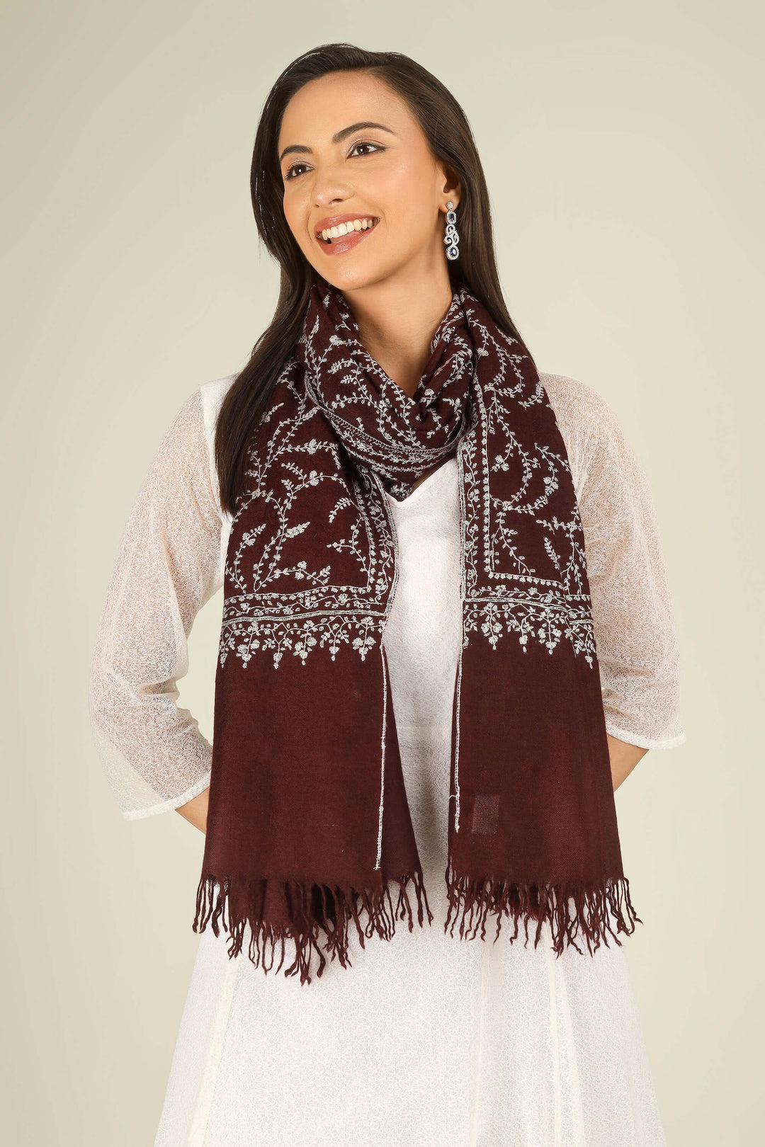 GI maroon Kashmiri pure pashmina embroidered stole by Kepra, draped on smiling model in white dress, front view for Kolkata winter styling