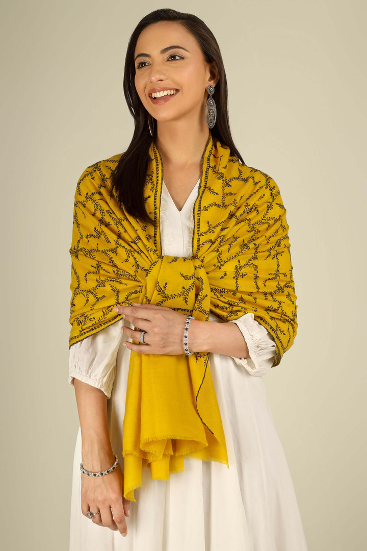 Yellow Kashmiri pure pashmina embroidered stole by Kepra, draped on smiling model in white dress, full-length front view for London winter styling
    
      | pashmina shawls online | authentic Kashmiri pashmina shawl online | pure pashmina shawl online | original GI certified pashmina shawl online | luxury men's pashmina shawl online from Kashmir | where to buy online pure pashmina in India
    
    | GI Tag Certified - Government-verified authentic Kashmiri Pashmina
    | G20 Official Partner - Selected by India for G20 Summit gifting
    | Handicraft Registered - Official recognition of traditional craftsmanship
    | Certificate of Authenticity - Every purchase includes GI certification