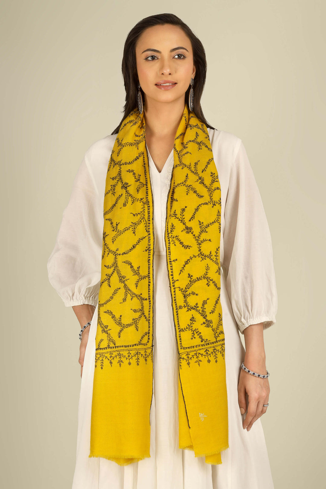 Yellow Kashmiri pure pashmina embroidered stole by Kepra, draped on smiling model in white dress, full-length front view for London winter styling