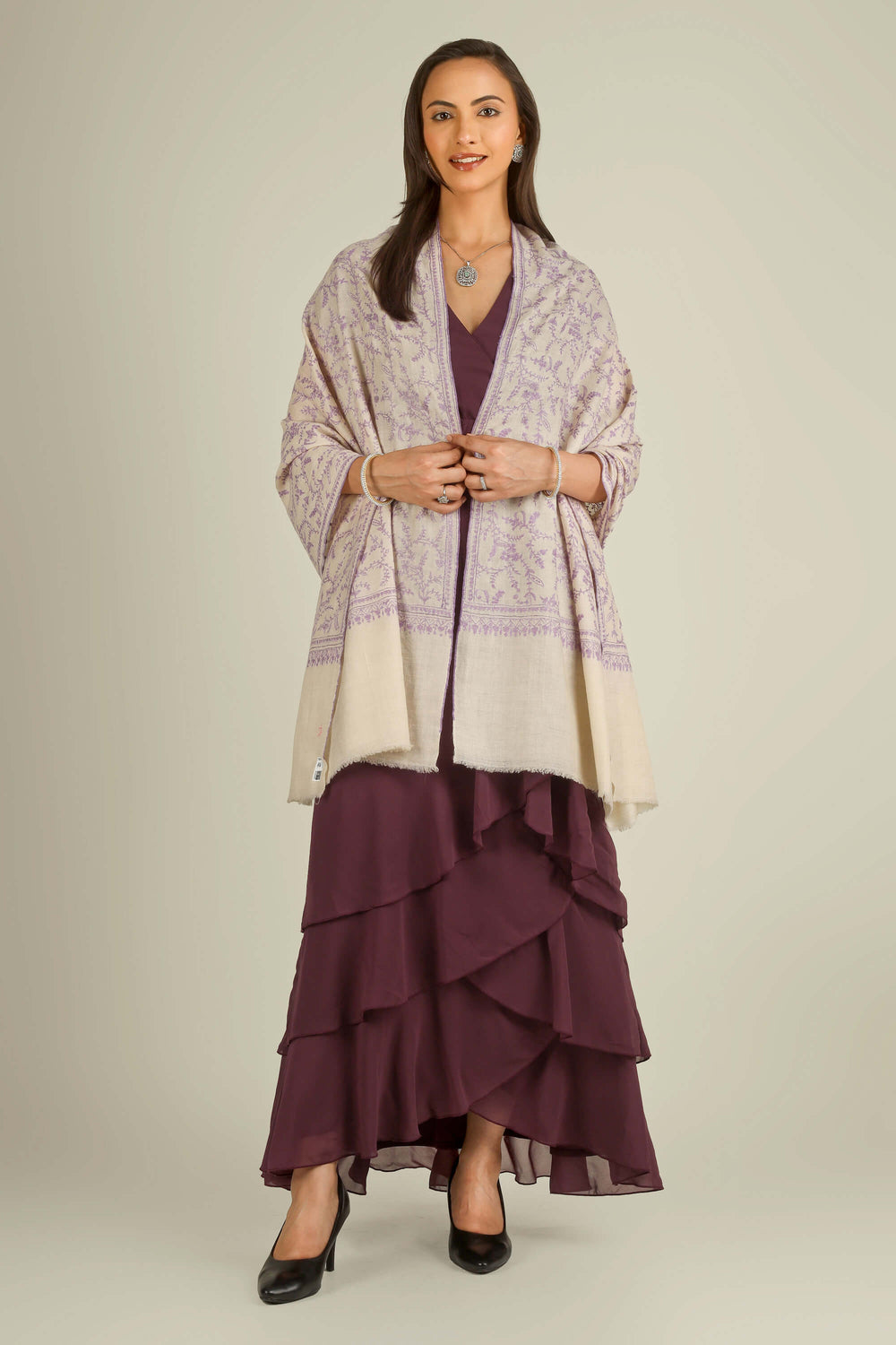 Ivory GI Kashmiri pure pashmina embroidered stole with lilac floral vines by Kepra, draped on model over plum dress, front view for Zurich winter styling