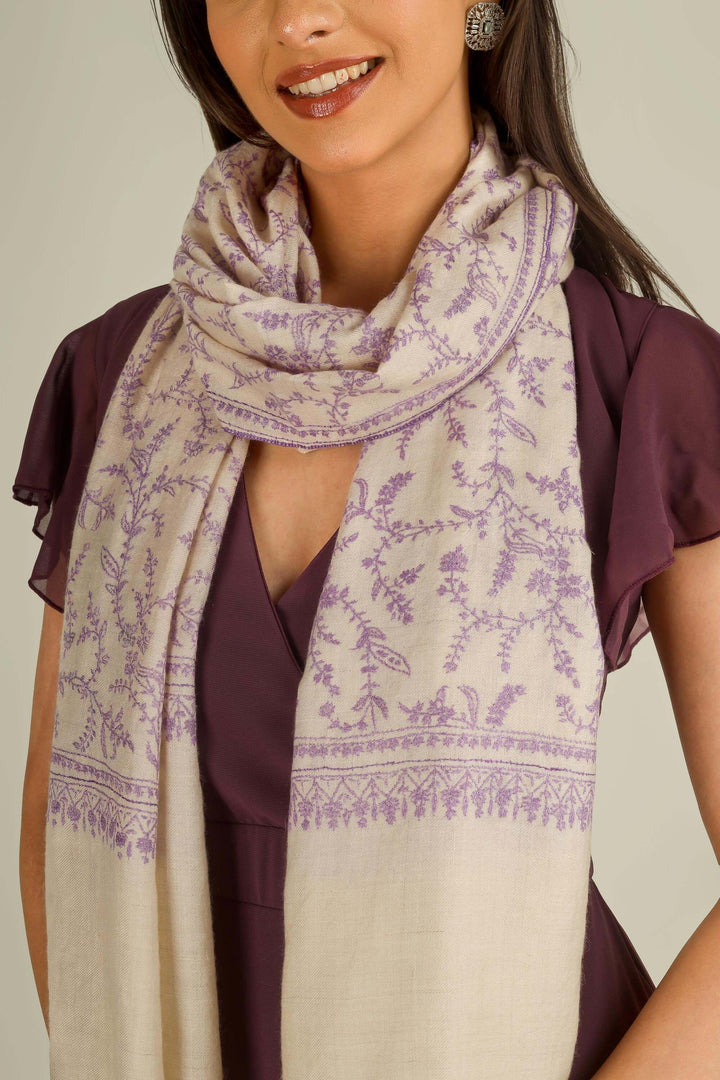 Ivory GI Kashmiri pure pashmina embroidered stole with lilac floral vines by Kepra, draped on model over plum dress, front view for Zurich winter styling
    
      | pashmina shawls online | authentic Kashmiri pashmina shawl online | pure pashmina shawl online | original GI certified pashmina shawl online | luxury men's pashmina shawl online from Kashmir | where to buy online pure pashmina in India
    
    | GI Tag Certified - Government-verified authentic Kashmiri Pashmina
    | G20 Official Partner - Selected by India for G20 Summit gifting
    | Handicraft Registered - Official recognition of traditional craftsmanship
    | Certificate of Authenticity - Every purchase includes GI certification