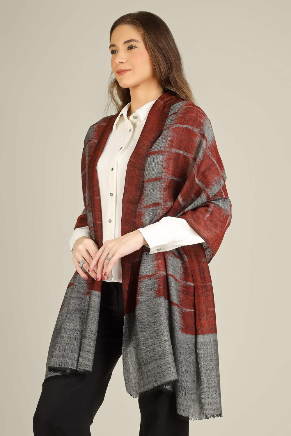 This pure pashmina stole features a sophisticated smoky grey base, overlaid with broad brushstroke checks in a rich maroon tone that give it a contemporary, painterly look while keeping the texture featherlight and soft