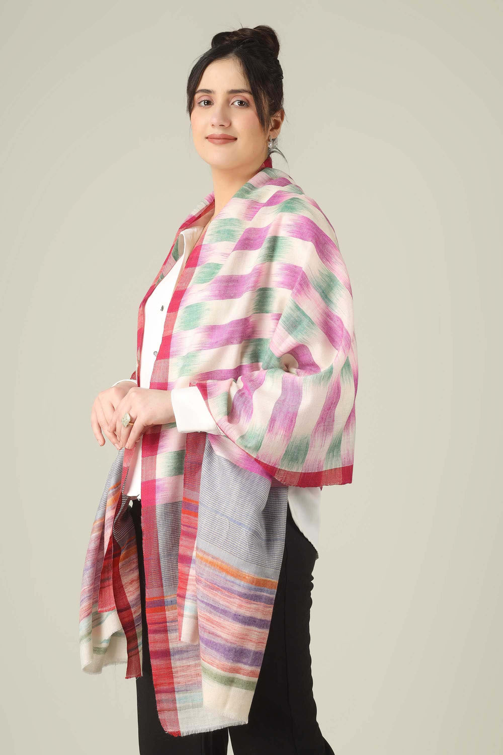 This pure pashmina stole from Kashmir is woven in joyful bands of pink, mint, lilac, grey, and sunset tones on an ivory base, giving you a painterly, multicolour finish that brightens any outfit.