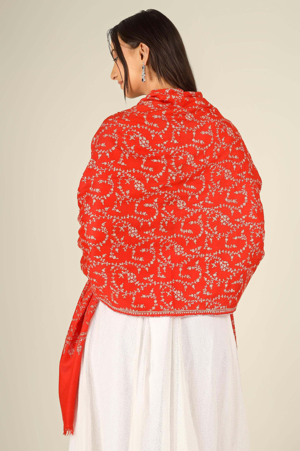 GI red Kashmiri pure pashmina embroidered stole by Kepra, draped on model in white dress, front view for Delhi winter styling
