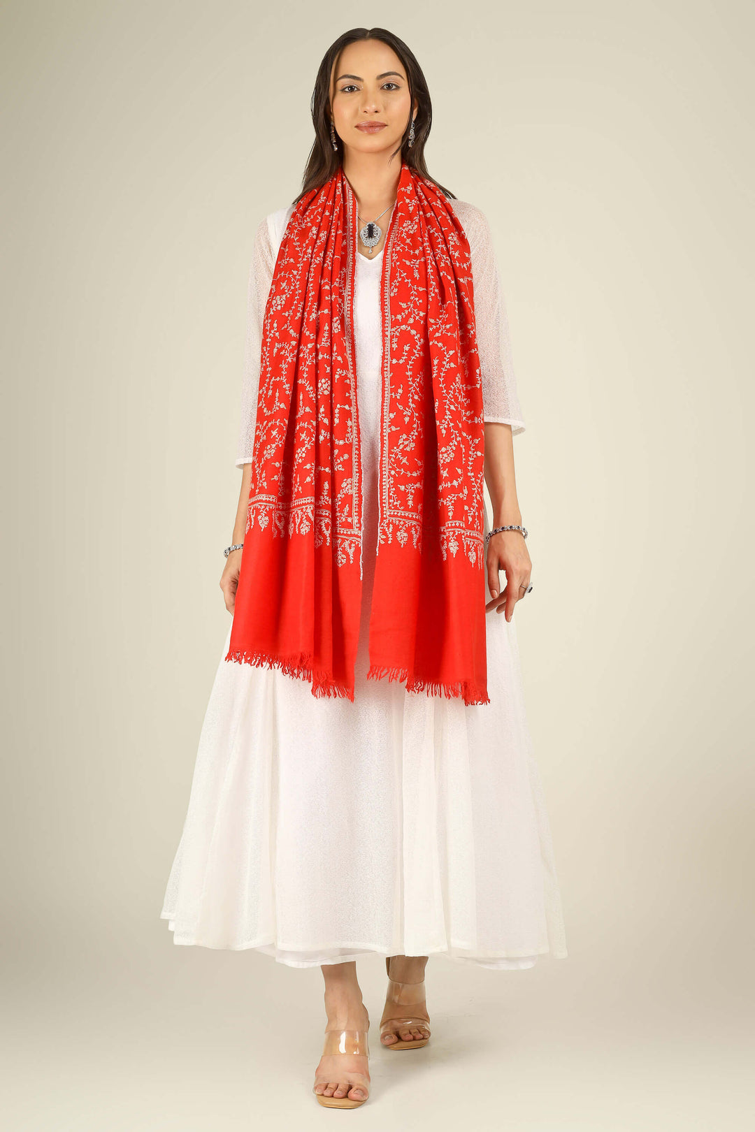 GI red Kashmiri pure pashmina embroidered stole by Kepra, draped on model in white dress, front view for Delhi winter styling